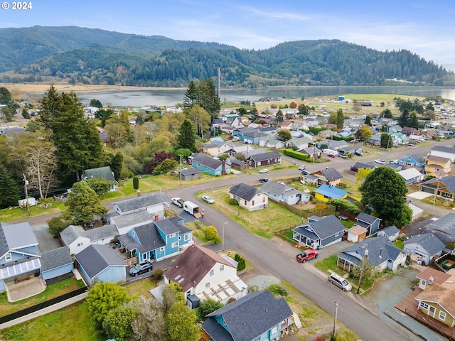 birds eye view of property with a water and mountain view