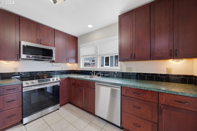 kitchen with sink, appliances with stainless steel finishes, and light tile patterned floors