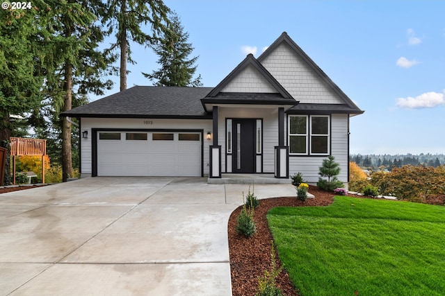 craftsman-style house featuring a garage and a front yard