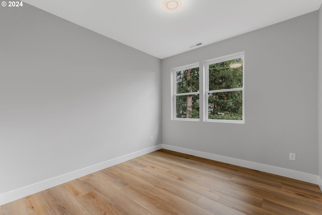 unfurnished room featuring hardwood / wood-style flooring