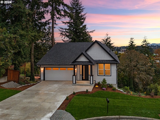 view of front of property featuring a lawn and a garage