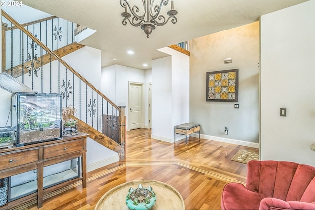 living room with wood-type flooring and a notable chandelier