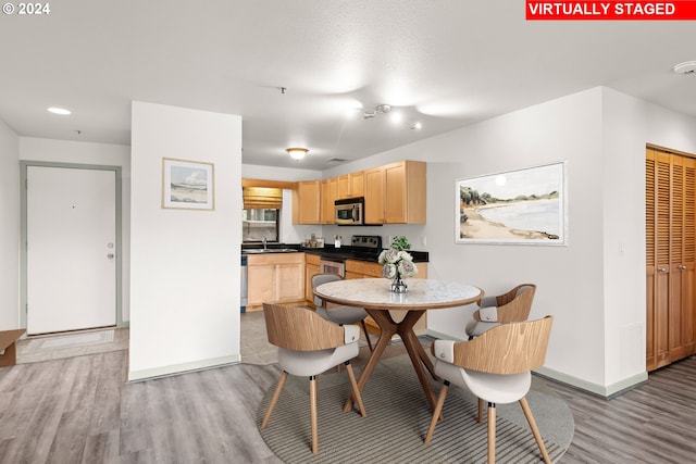 dining room featuring light hardwood / wood-style flooring and sink