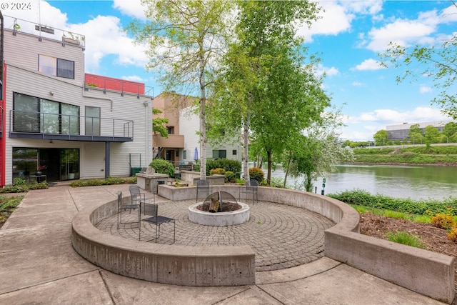 view of nearby features featuring a patio, an outdoor fire pit, and a water view