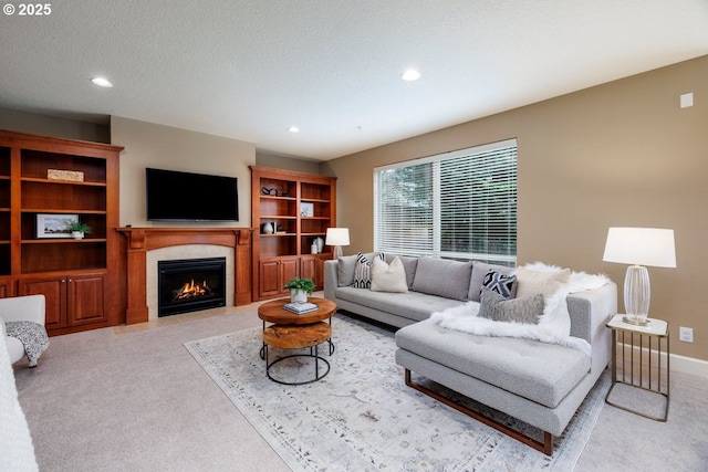 5310 NW Primino Ave, Portland, OR 97229 - carpeted living room featuring a fireplace with flush hearth, recessed lighting, baseboards, and a textured ceiling