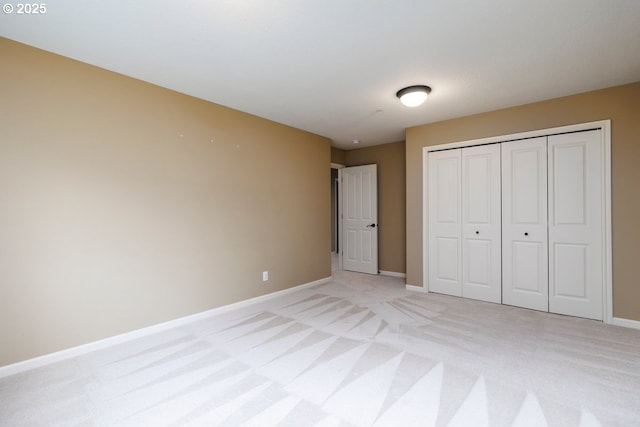 5310 NW Primino Ave, Portland, OR 97229 - unfurnished bedroom featuring a closet, baseboards, and light colored carpet