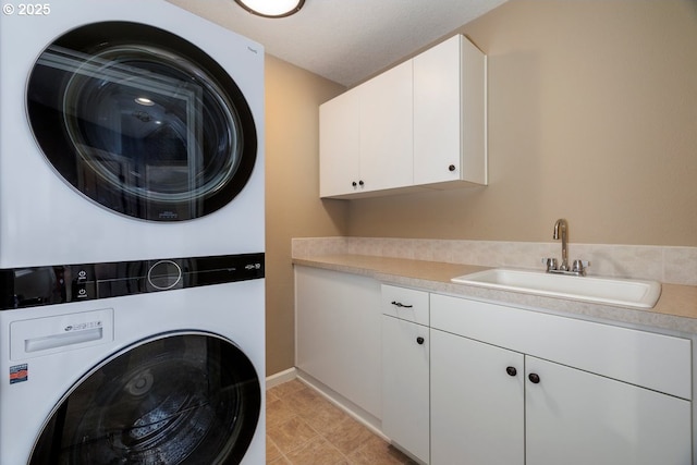 5310 NW Primino Ave, Portland, OR 97229 - clothes washing area with light tile patterned flooring, cabinet space, stacked washer and clothes dryer, and a sink