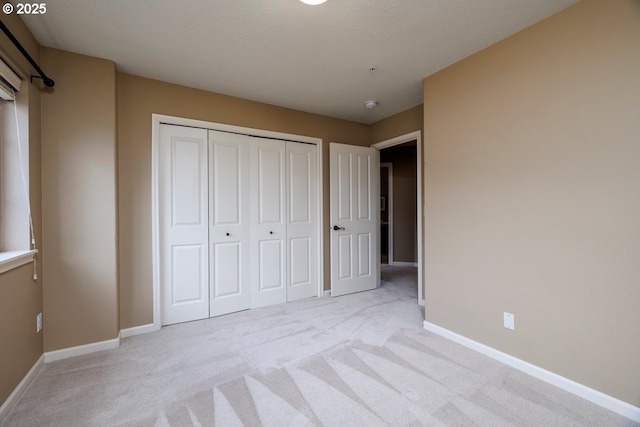 5310 NW Primino Ave, Portland, OR 97229 - unfurnished bedroom featuring light carpet, a closet, and baseboards