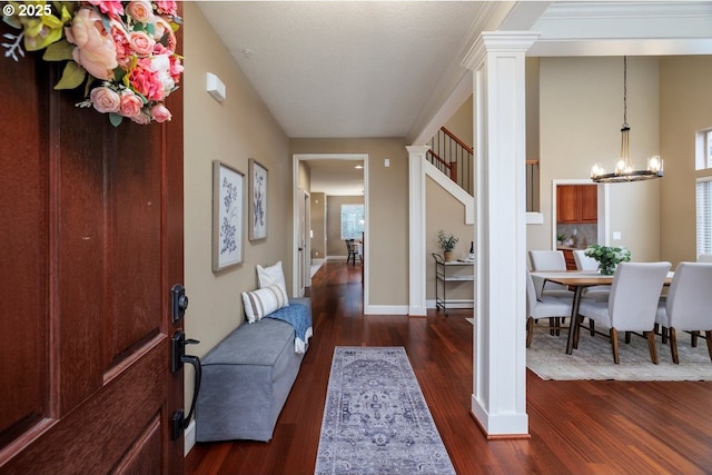 5310 NW Primino Ave, Portland, OR 97229 - foyer entrance with wood finished floors, baseboards, ornate columns, and a chandelier