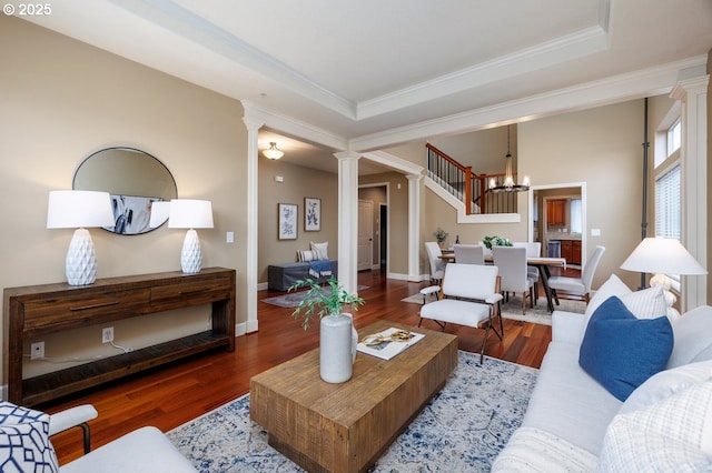 5310 NW Primino Ave, Portland, OR 97229 - living room featuring decorative columns, a raised ceiling, wood finished floors, and crown molding