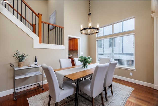 5310 NW Primino Ave, Portland, OR 97229 - dining space with a high ceiling, wood finished floors, baseboards, and a chandelier