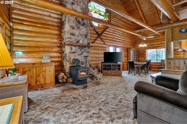 carpeted living area featuring wooden ceiling, ceiling fan, a wood stove, high vaulted ceiling, and beam ceiling