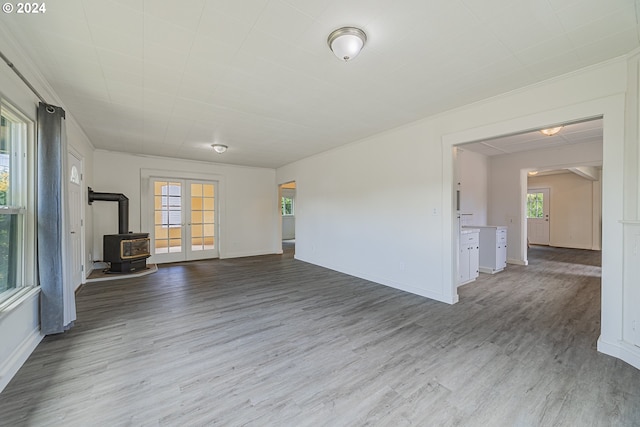 unfurnished living room featuring hardwood / wood-style flooring and a wood stove