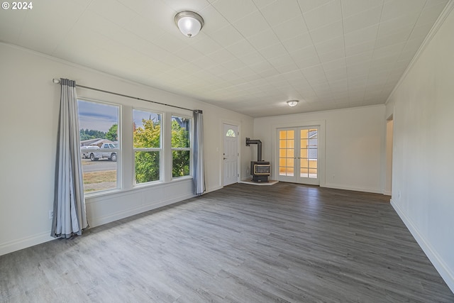 unfurnished living room with hardwood / wood-style floors and a wood stove