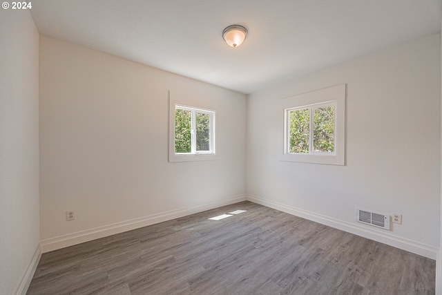 spare room with wood-type flooring