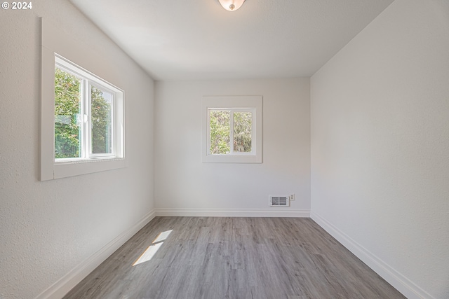 unfurnished room with light hardwood / wood-style floors