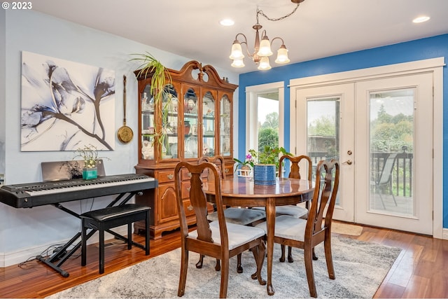 dining space featuring hardwood / wood-style floors and a notable chandelier