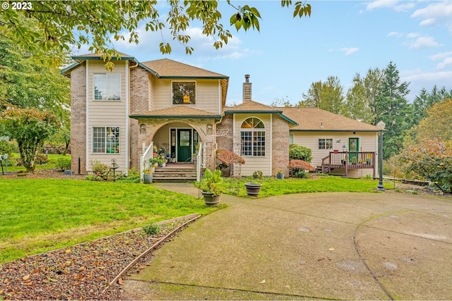 rear view of property with a lawn