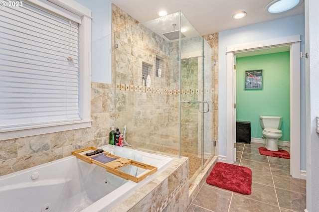 bathroom featuring tile patterned flooring, toilet, and independent shower and bath