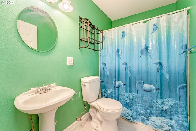 bathroom with tile patterned floors, a shower with curtain, and toilet