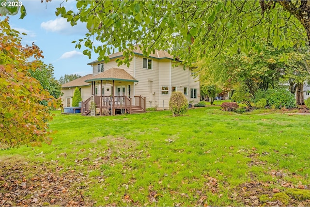 rear view of house featuring a lawn