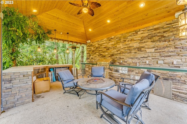 view of patio with a grill, ceiling fan, and exterior kitchen