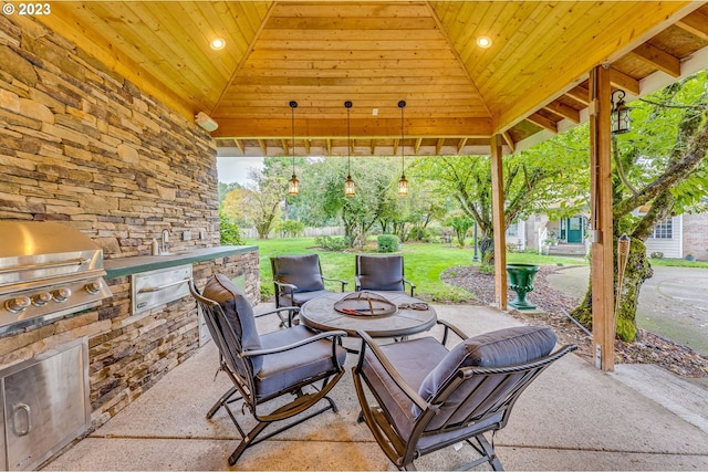 view of patio / terrace featuring an outdoor kitchen, a fire pit, and grilling area