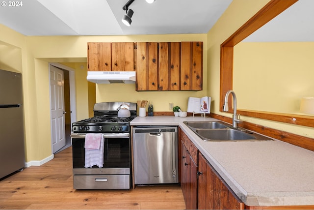 kitchen with rail lighting, light hardwood / wood-style floors, appliances with stainless steel finishes, and sink