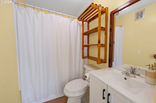 bathroom featuring hardwood / wood-style floors, vanity, toilet, and a shower with shower curtain