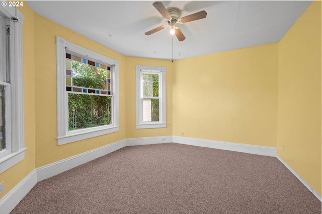 carpeted empty room featuring ceiling fan