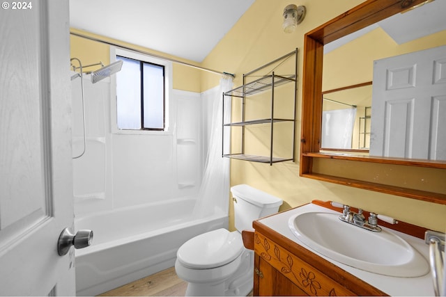 full bathroom featuring toilet, wood-type flooring, shower / bathing tub combination, vaulted ceiling, and vanity