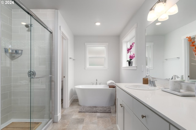 bathroom featuring vanity and plus walk in shower