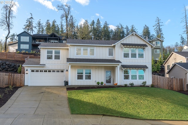 view of front of property featuring a front yard and a garage