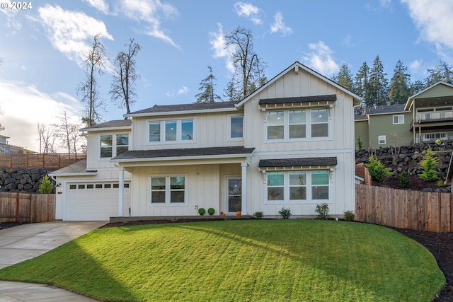 view of front of property featuring a front yard and a garage