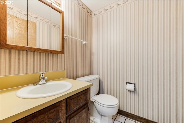 bathroom with tile patterned floors, vanity, and toilet