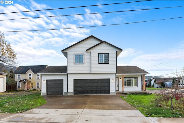 view of property with a front lawn and a garage