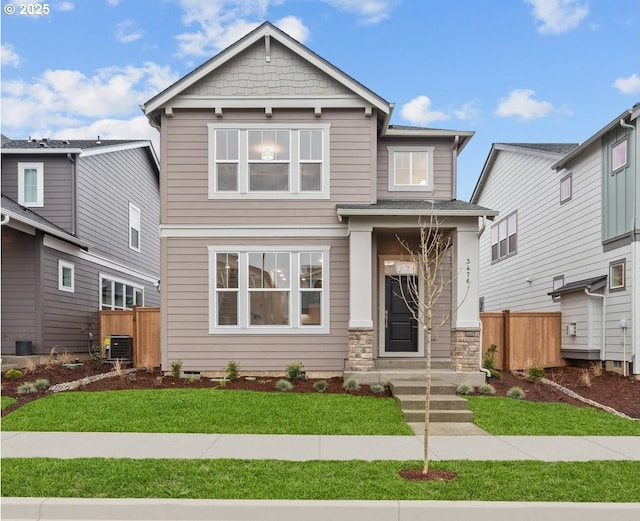 craftsman house featuring a front yard and cooling unit