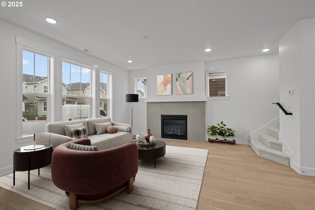 living room featuring a fireplace and light hardwood / wood-style flooring