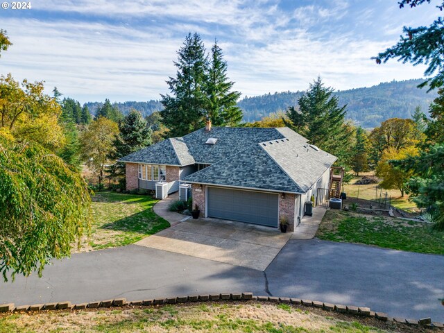 14355 NW Pheasant Hill Ln, Mcminnville, OR 97128 - view of front of home with an attached garage, brick siding, concrete driveway, a shingled roof, and a front yard