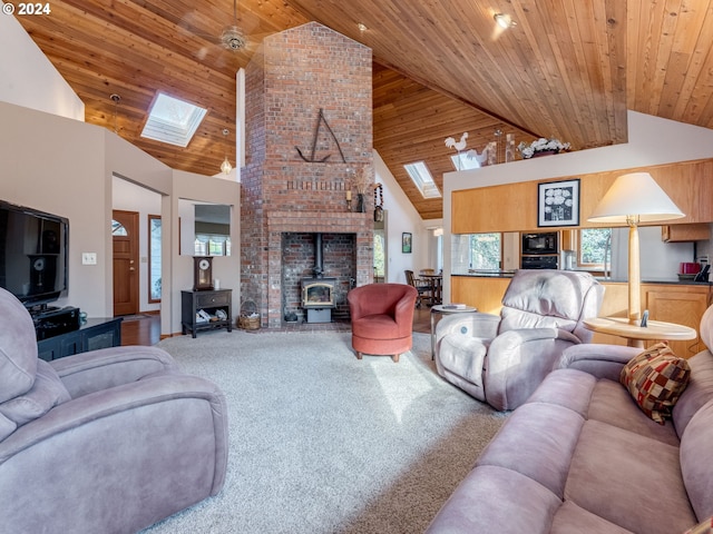 14355 NW Pheasant Hill Ln, Mcminnville, OR 97128 - carpeted living room with a wood stove, a skylight, wooden ceiling, and high vaulted ceiling