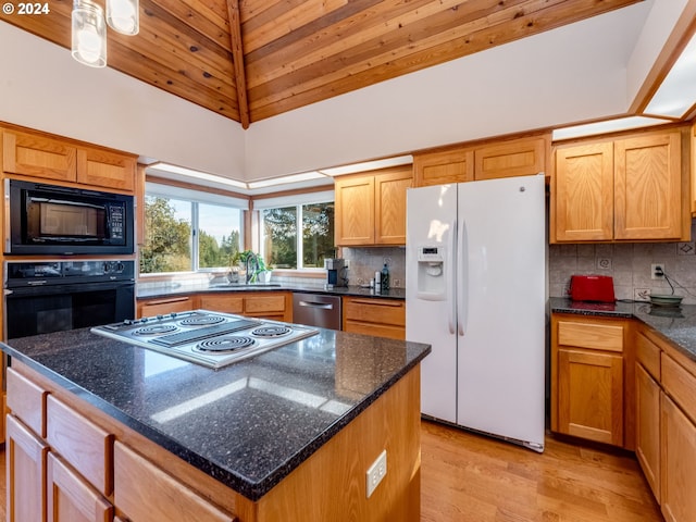 14355 NW Pheasant Hill Ln, Mcminnville, OR 97128 - kitchen with black appliances, high vaulted ceiling, a kitchen island, tasteful backsplash, and light wood-style flooring