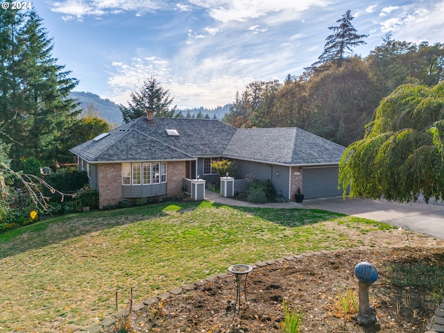 14355 NW Pheasant Hill Ln, Mcminnville, OR 97128 - ranch-style house with driveway, an attached garage, a front lawn, brick siding, and central air condition unit