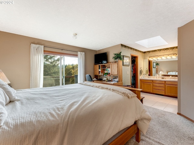 14355 NW Pheasant Hill Ln, Mcminnville, OR 97128 - bedroom with a skylight, access to exterior, ensuite bathroom, light carpet, and light tile patterned flooring