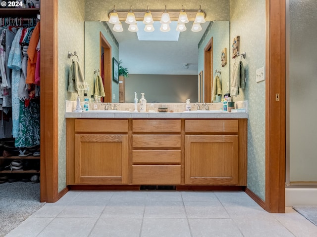 14355 NW Pheasant Hill Ln, Mcminnville, OR 97128 - full bath featuring double vanity, wallpapered walls, a walk in closet, and baseboards
