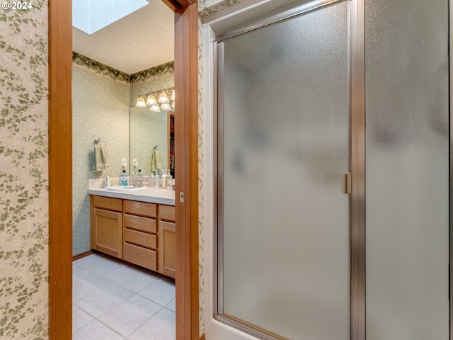 14355 NW Pheasant Hill Ln, Mcminnville, OR 97128 - full bath featuring double vanity, wallpapered walls, a stall shower, a skylight, and tile patterned flooring