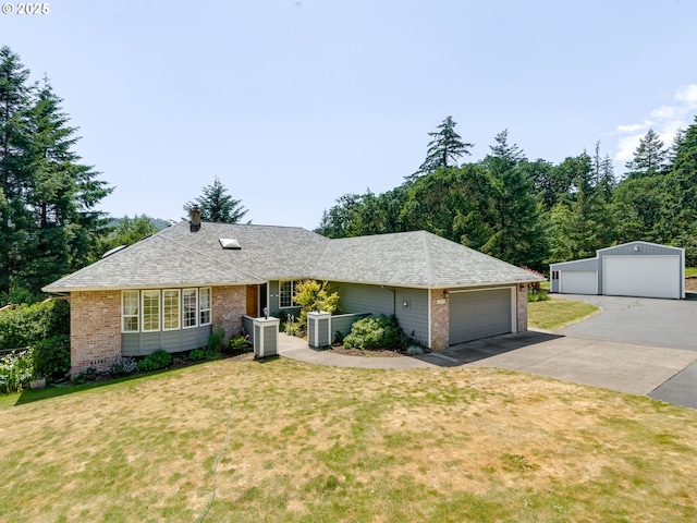 14355 NW Pheasant Hill Ln, Mcminnville, OR 97128 - single story home with brick siding, a front lawn, central AC unit, and a detached garage