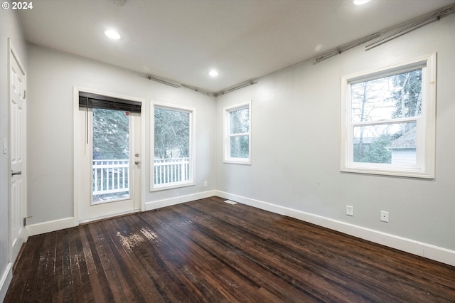 empty room with dark wood-type flooring