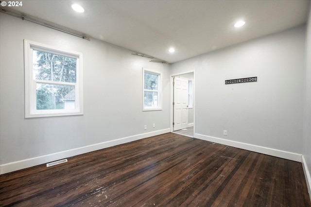 unfurnished room featuring dark hardwood / wood-style flooring