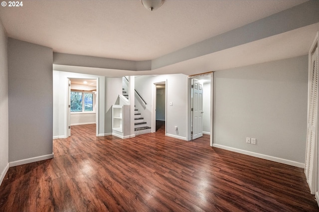 basement with dark hardwood / wood-style flooring