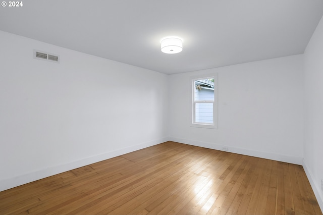 spare room featuring wood-type flooring